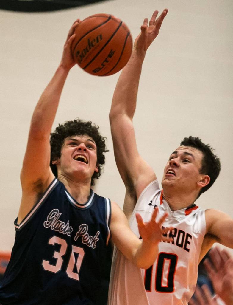 Glacier Peaks Bobby Martin (left) attempts a shot with Monroes Spencer Davidson defending during a game Jan. 10, 2018, at Monroe High School. The Grizzlies won 73-52. (Kevin Clark / The Herald)