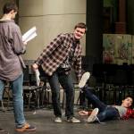 Kamiak student Aidan Norris (center) drags Matthew Ninh into a scene as Mitchell Beard (left) reads his lines. (Ian Terry / The Herald)