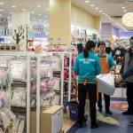 Employees show a mattress to customers at a Babemax store in Shanghai, China, on Dec. 22. (Bloomberg/Qilai Shen)