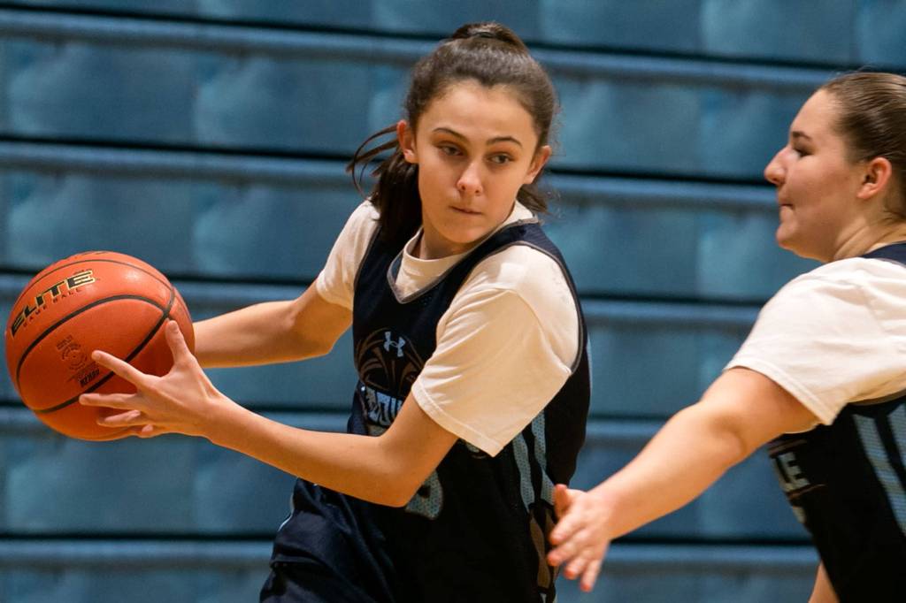 Meadowdale freshman Hayley Kesselring drives past Karina Gorbatyuk during practice Jan. 11, 2018, at Meadowdale High School in Lynnwood. (Kevin Clark / The Herald)