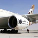 Attendees pass an Airbus A380 passenger aircraft, operated by Etihad Airways, on the tarmac during the 15th Dubai Air Show at Dubai World Central in Dubai, United Arab Emirates, on Nov. 13, 2017. (Natalie Naccache/Bloomberg)