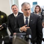 Gov. Jay Inslee (center) addresses media Thursday before touring Snohomish Countys former work release building in downtown Everett. The building will be repurposed as a diversion center for struggling addicts by spring. (Ian Terry / The Herald)