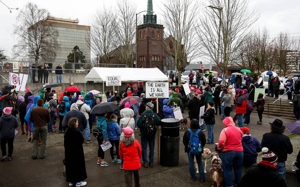 A crowd gathers for a rally to protest the 1-year anniversary of the inauguration of President Donald Trump on Saturday. (Ian Terry / The Herald)