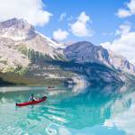 A kayaker and a canoer paddle on Maligne Lake in Jasper National Park. (Tourism Jasper)