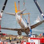 Cranes lift a Boeing 737-800 of Turkeys Pegasus Airlines in Trabzon, Turkey, on Thursday. The plane skidded off a runway and stopped on a slope meters away from the Black Sea on Saturday. (AP Photo/Lefteris Pitarakis)