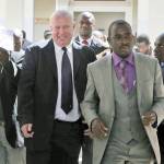 In this May 2010 photo, Roy Bennett (center left) leaves the High Court in Harare, Zimbabwe, after he was acquitted of terrorism charges. (AP Photo/Tsvangirayi Mukwazhi, File)