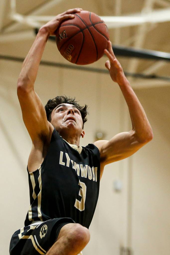 Lynnwoods Alex Macias takes a shot during a game against Meadowdale at Meadowdale High School in Lynnwood on Jan. 16. (Ian Terry / The Herald)