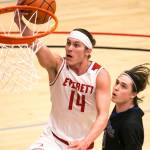 Everett Community Colleges Conner Moffatt (14) drives for a layup with Edmonds Community Colleges Jake Higgins trailing during a game Jan. 20, 2018, at the Walt Price Student Fitness Center in Everett. The Trojans won 117-100. (Kevin Clark / The Herald)
