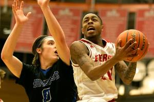 Everetts Tori Odom, right, attempts a shot with Edmonds Jake Higgins defending Saturday night at the Walt Price Student Fitness Center in Everett on January 20, 2018. The Trojans won 117-100. (Kevin Clark / The Daily Herald)
