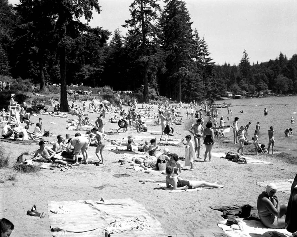 Sunbathers at Lake Goodwin State Park (Wenberg Park) near Stanwood in June 1958. Librarian Rob Branigin hopes to record oral histories, including stories about what it was like growing up around Stanwood in the mid-20th century. (Herald file)