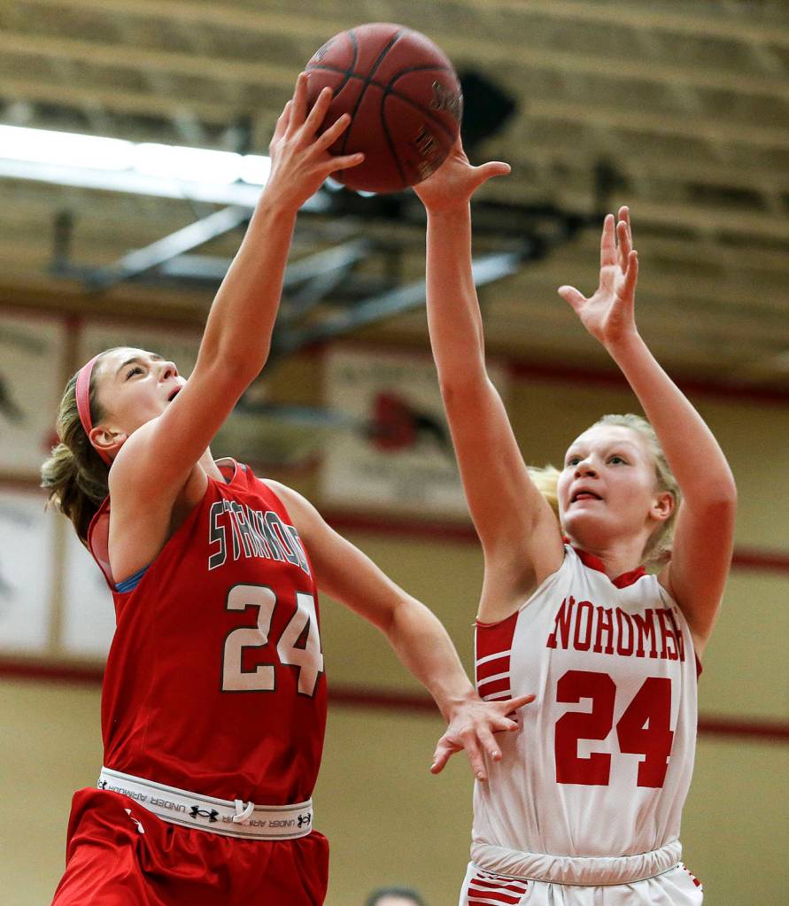 Stanwoods Jillian Heichel (left) takes a shot as Snohomishs Kaylin Beckman (right) defends during a game Jan. 24, 2018, at Snohomish High School. (Ian Terry / The Herald)