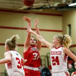Stanwoods Madison Chisman (center) takes a shot between Snohomish defenders Kyra Beckman (left) and Kaylin Beckman (right) during a game Jan. 24, 2018, at Snohomish High School. (Ian Terry / The Herald)