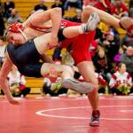 Marysville Pilchucks Austin Davis (right) slams Arlingtons Todd Smith during a wrestling match Thursday night at Marysville-Pichuck High School. (Kevin Clark / The Daily Herald)