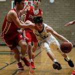 Arlingtons Anthony Whitis (right) drives to the hoop during a game against Stanwood on Jan. 26, 2018, at Arlington High School. (Ian Terry / The Herald)