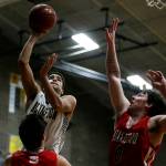 Arlingtons Ayodele Aribibola (left) takes a shot as Stanwoods Mitch Jones (right) defends during a game on Jan. 26, 2018, at Arlington High School. (Ian Terry / The Herald)