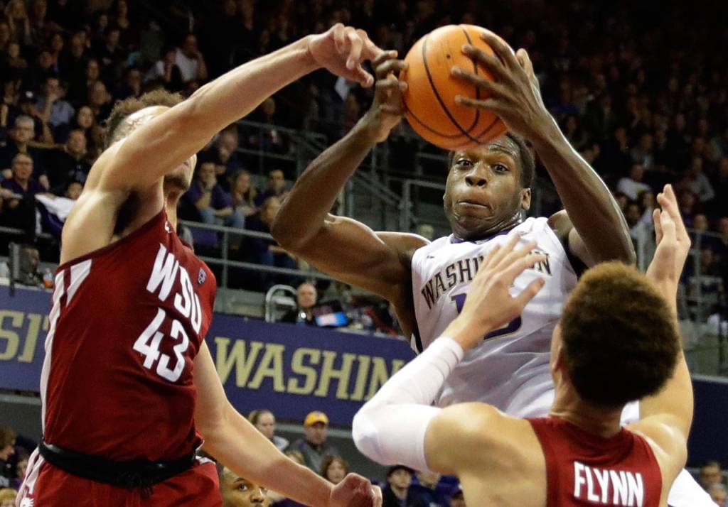 Washington forward Noah Dickerson grabs a rebound between Washington State forward Drick Bernstine (43) and guard Malachi Flynn during Sundays game in Seattle. (AP Photo/Ted S. Warren)