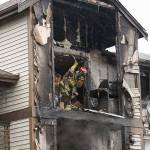 Firefighters work on an apartment fire in south Everett on Monday. Crews from as far away as Shoreline and Marysville were at the scene, assisting Everett firefighters. (Andy Bronson / The Herald)
