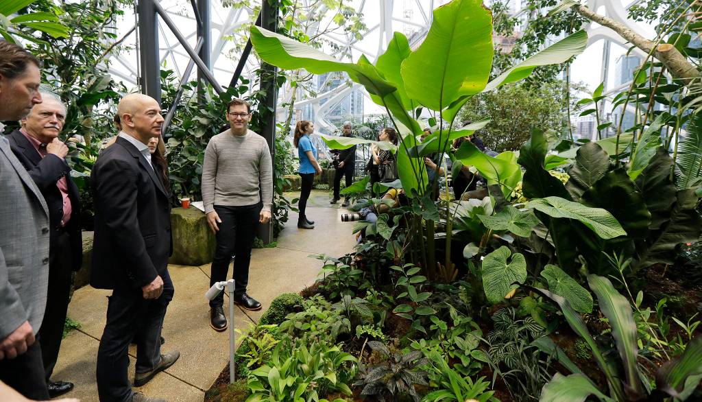 Jeff Bezos (third from left), the CEO and founder of Amazon.com, takes a walking tour of the Amazon Spheres following a grand opening ceremony Monday in Seattle. (AP Photo/Ted S. Warren)