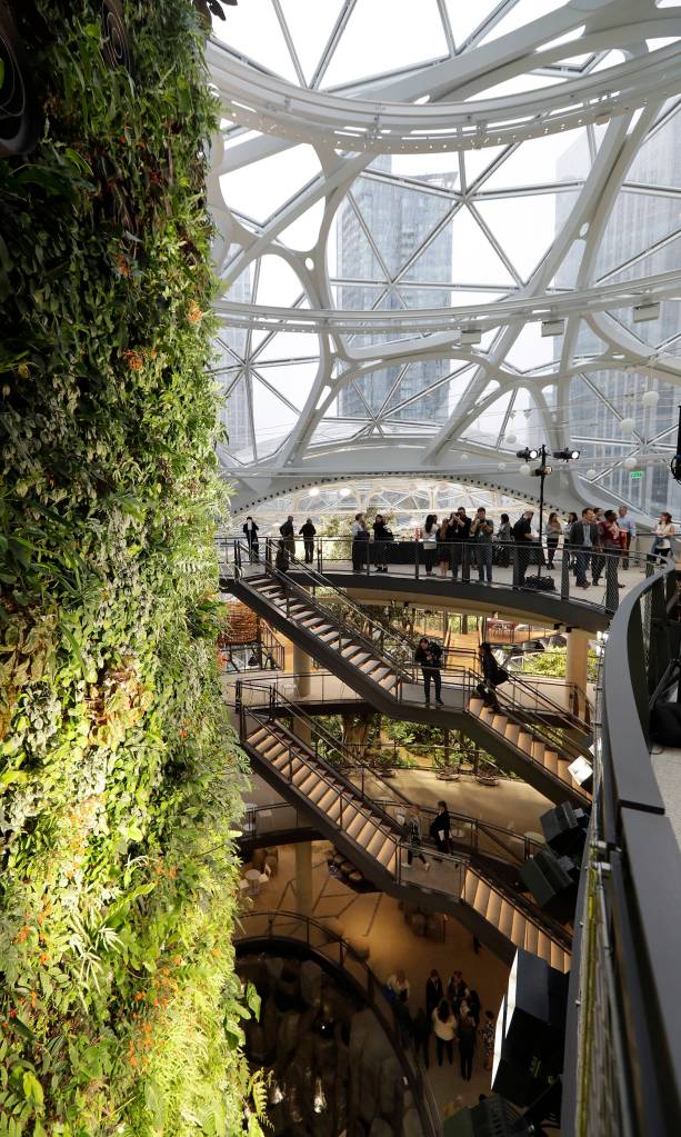 Gathering spaces and a plant-filled wall are shown before a grand opening ceremony for the Amazon Spheres on Monday in Seattle. (AP Photo/Ted S. Warren)