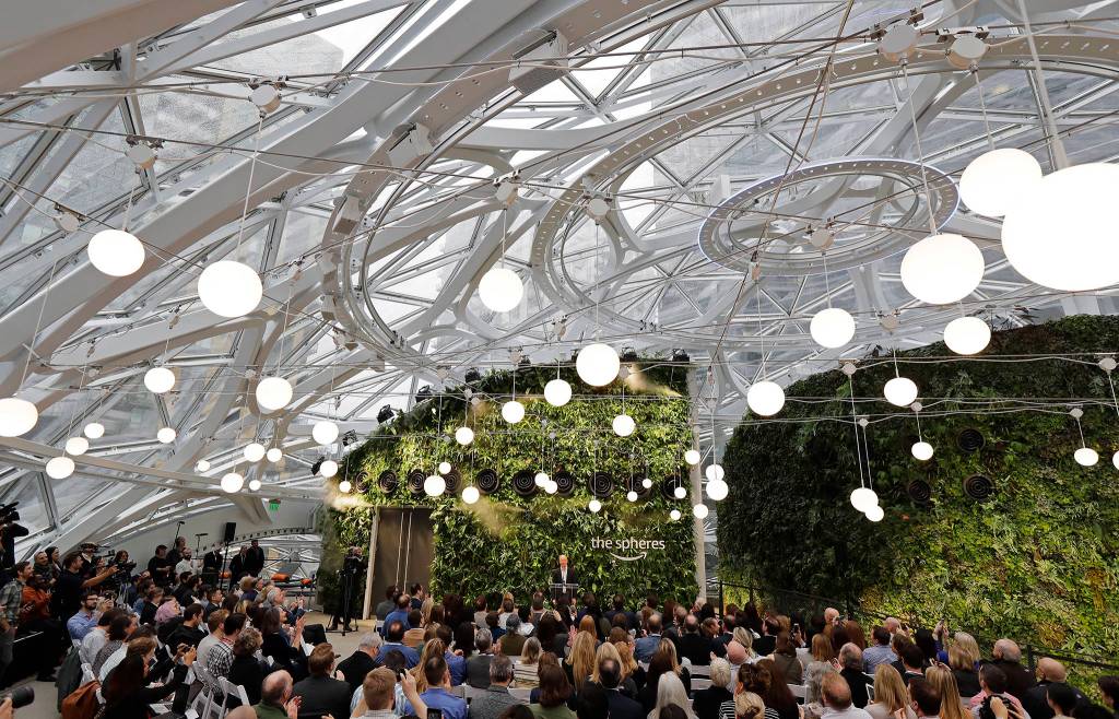 Guests listen as Jeff Bezos, the CEO and founder of Amazon.com, speaks during the grand opening of the Amazon Spheres on Monday in Seattle. (AP Photo/Ted S. Warren)