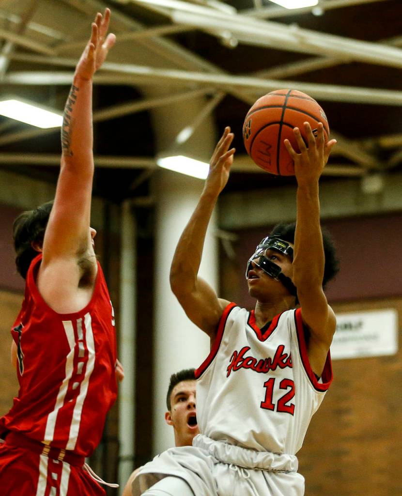 Mountlake Terraces Connor Williams (right) takes a shot during a game against Stanwood at Mountlake Terrace High School on Tuesday, Jan. 30. (Ian Terry / The Herald)