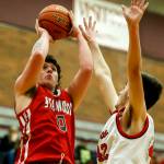 Stanwoods Mitch Jones (left) takes a shot as Mountlake Terraces Max Hull (right) defends during a game at Mountlake Terrace High School on Tuesday, Jan. 30. (Ian Terry / The Herald)