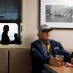 Tom French, of Freeland, looks at his cellphone while enjoying a Diamond Knot IPA during his commute home via the ferry. (Andy Bronson / The Herald)