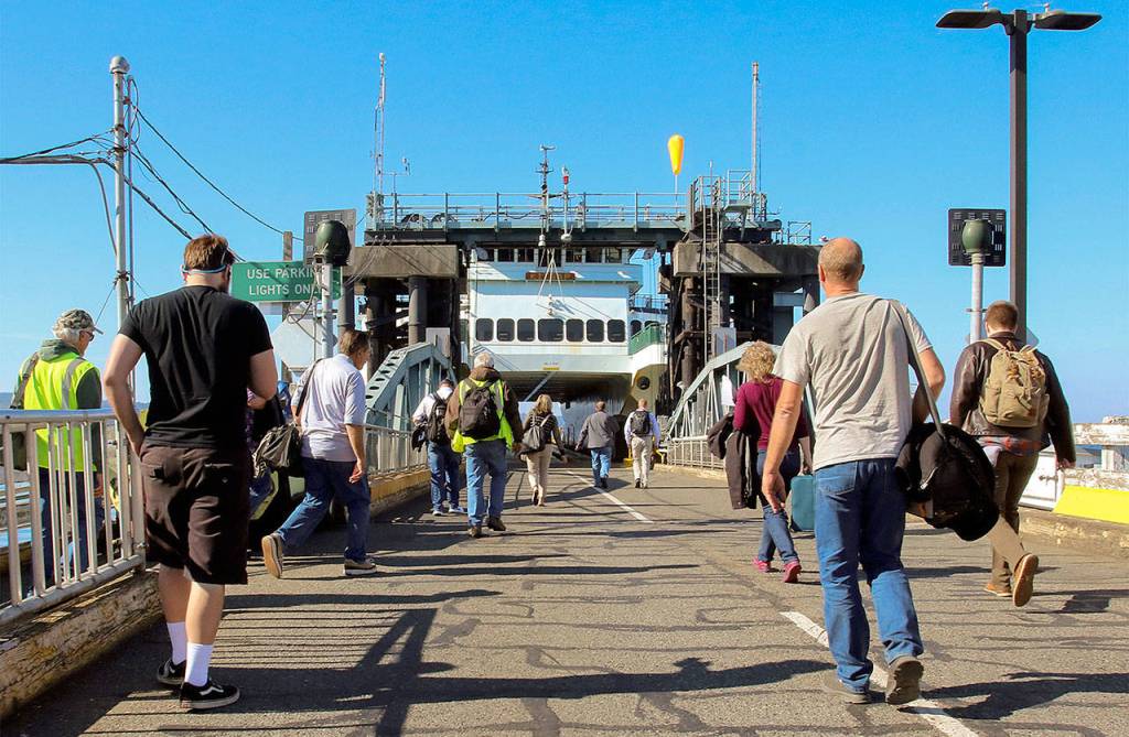 Commuters make their way to a ferry on the Mukilteo-Clinton run. (Kevin Clark / The Herald)
