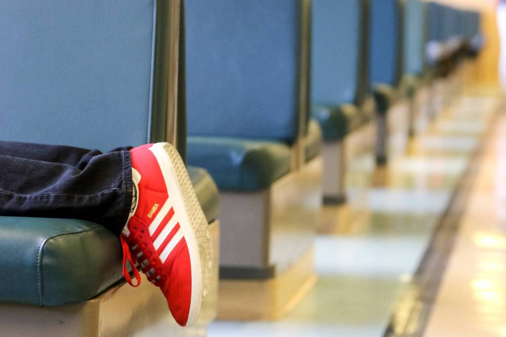 A commuter sprawls out on a booth seat during a morning run. (Kevin Clark / The Herald)