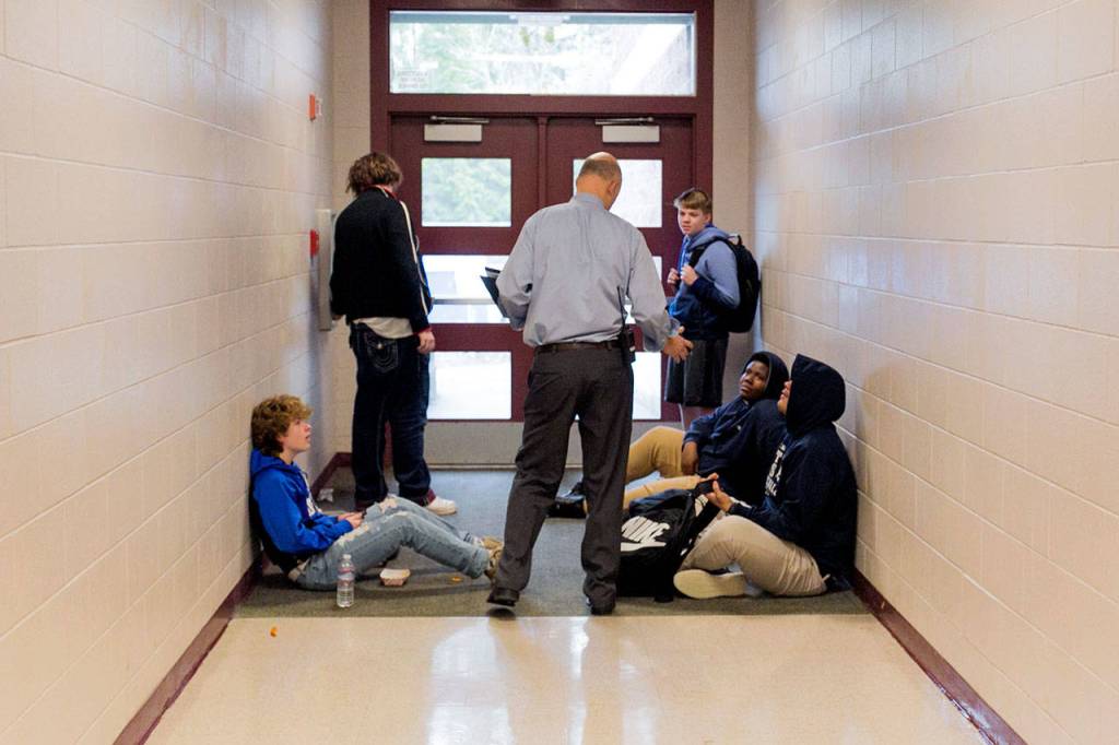 Principal Dave Peters addresses students about be in the hall without a pass Monday morning at Henry M. Jackson High School in Mill Creek on Jan. 22. (Kevin Clark / The Daily Herald)