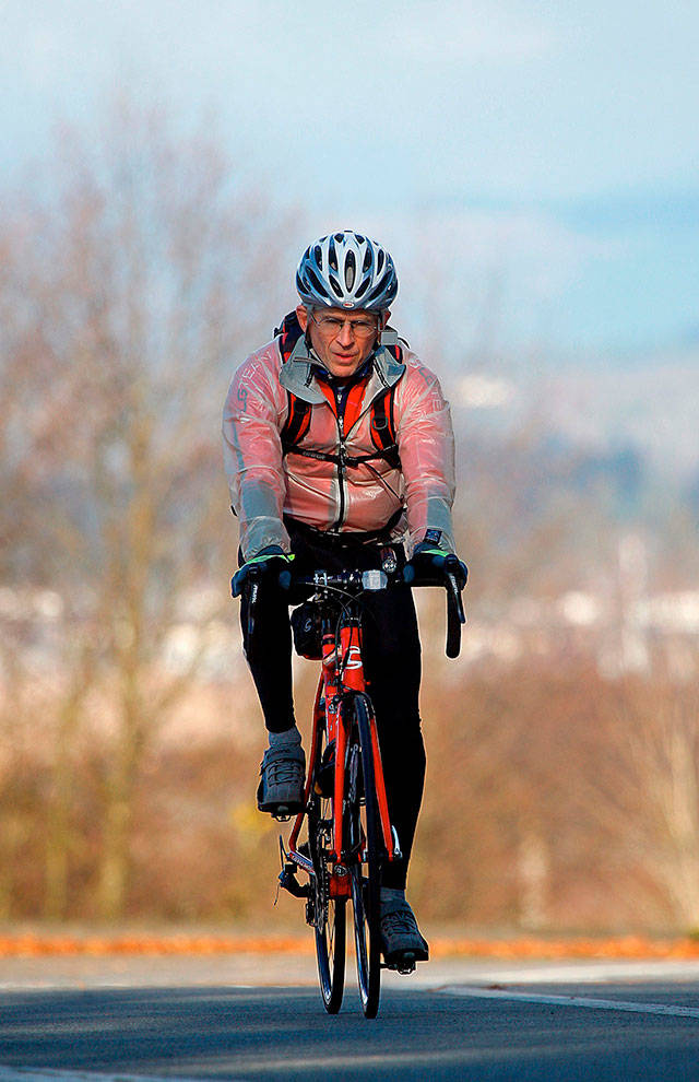 Dr. Art Grossman rides south, past the bluff at Legion Park in Everett. on a sunny winter day in early February 2013. The Everett family practice physician, soccer coach and YMCA fitness instructor died Dec. 21 of ALS. (Dan Bates / Herald file)