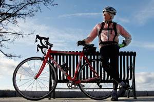 Dr. Art Grossman, a longtime Everett family practice physician, soccer coach and YMCA fitness instructor, died Dec. 21 of ALS. Grossman is seen here in 2013, stopped along Marine View Drive in Everett with his bike. (Dan Bates / The Herald)