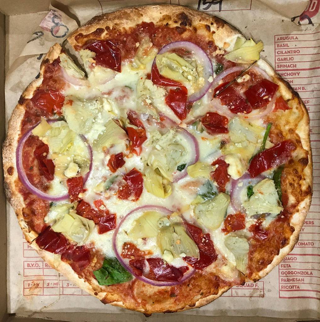 An 11-inch pizzA with red sauce, artichokes, broccoli, cauliflower and peppers from MOD Pizza is $8.27. (Andrea Brown/The Herald)