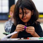 Emerson Elementary third-grader Roxy Deakin, 8, contemplates where she might place a shiny star and on a Valentines Day card that she is making to put in a Buddy Bag to give people in a local nursing home. (Dan Bates / The Herald)