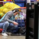 Kelly Hills check her sound gear before the performance. (Kevin Clark / The Daily Herald)