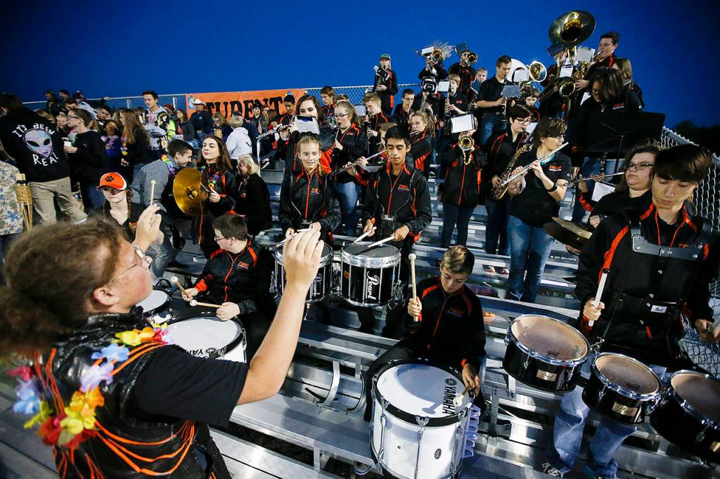 Sage Strecker (left), drum major for Granite Falls High School, leads the band through a quick tune during a timeout in the first quarter of a football game at the school in 2016. (Ian Terry / Herald file)