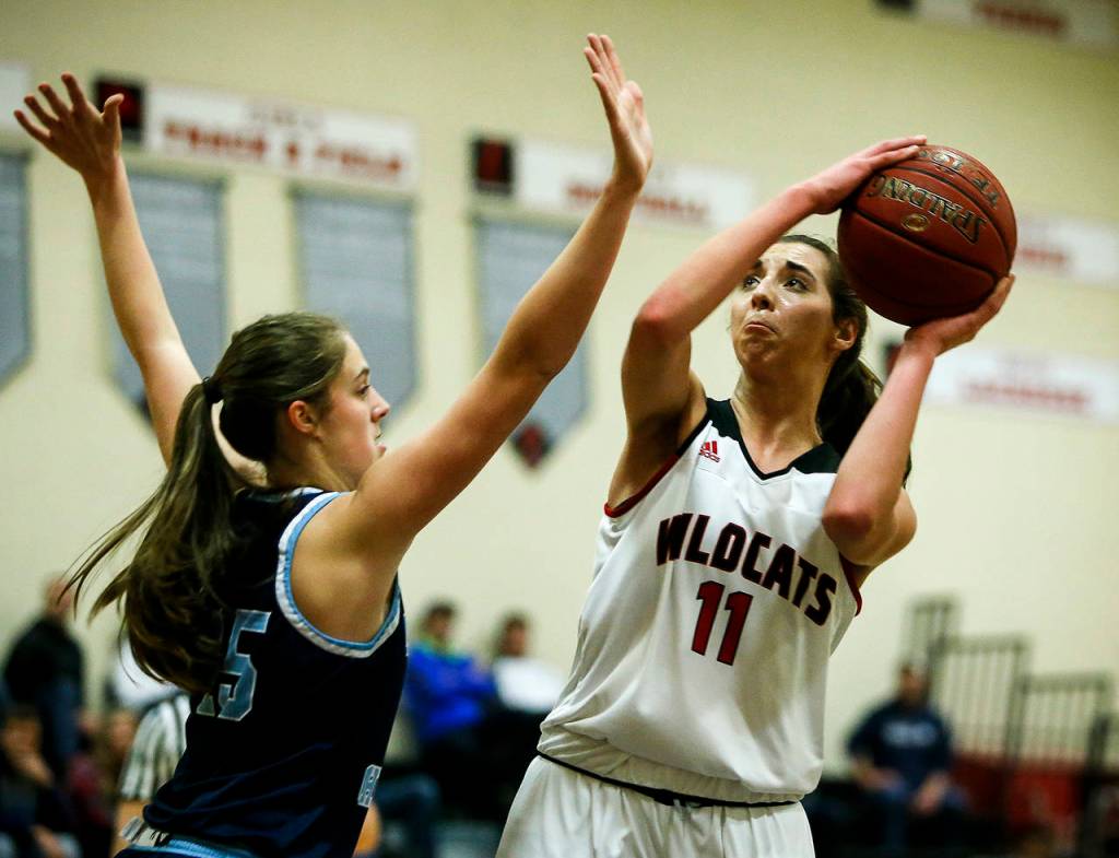 Archbishop Murphys Megan Dorney (right) takes a shot as Lynden Christians Grace Sterk (left) defends during a non-conference showdown Thursday in Everett. Dorney and the Wildcats lost 44-31. (Ian Terry / The Herald)