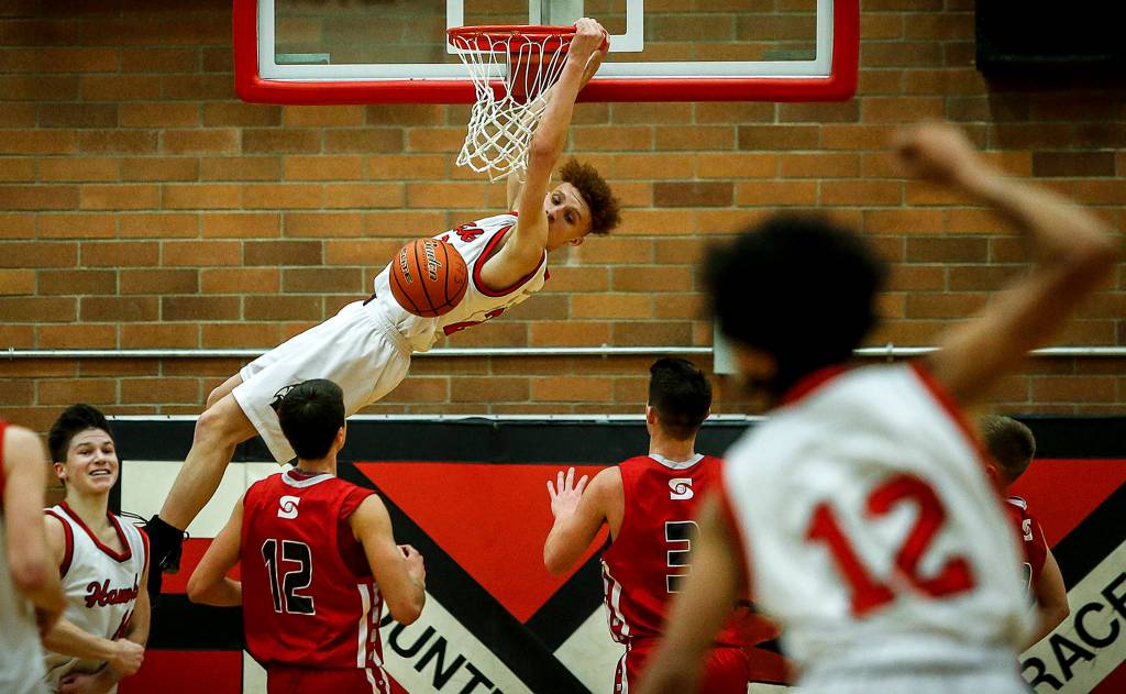 Mountlake Terraces Khyree Amrstead (center) throws down a dunk during a decisive victory over Stanwood at Mountlake Terrace High School on Jan. 30. (Ian Terry / The Herald)