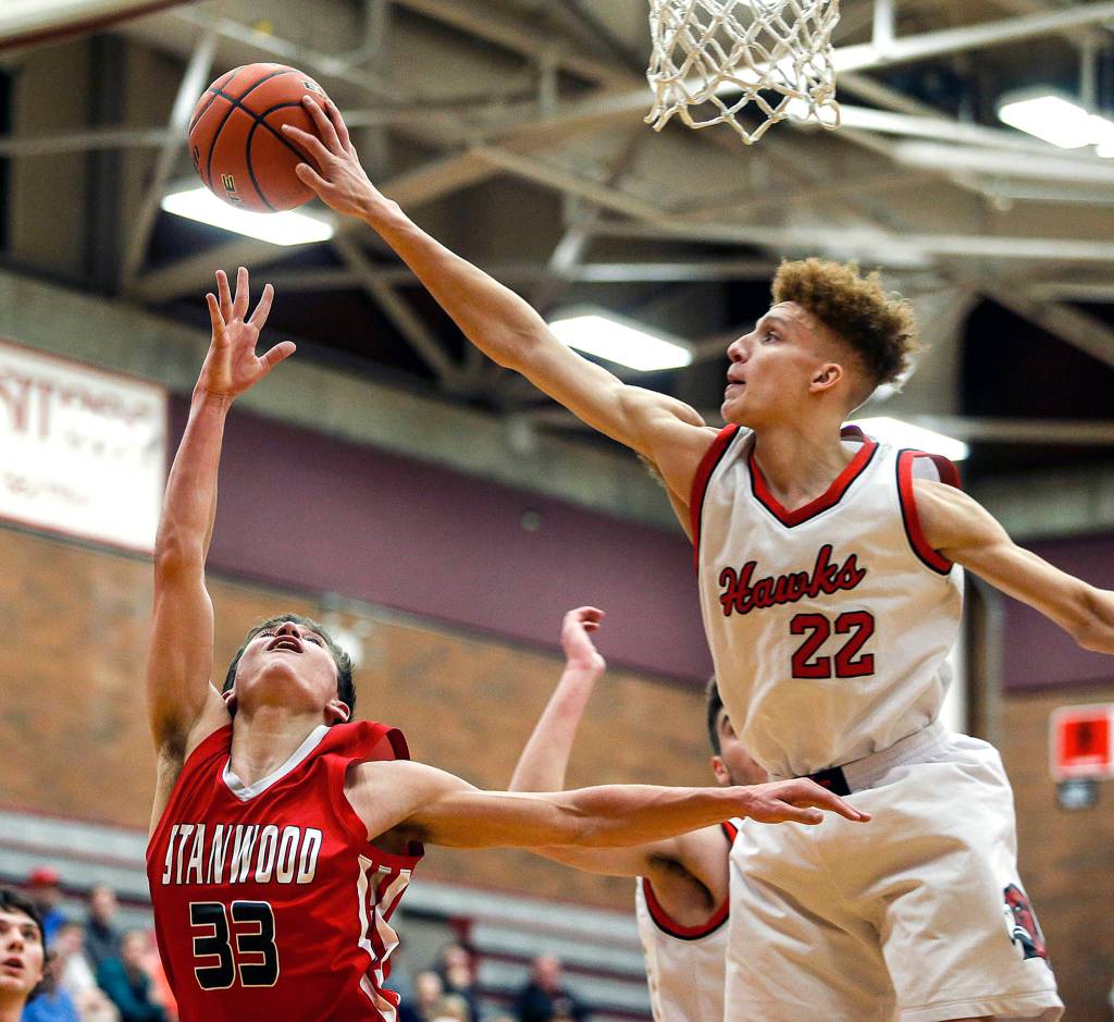 Mountlake Terraces Khyree Amrstead (22) blocks a shot attempt by Stanwoods Nate Kummer (33) during a game at Mountlake Terrace High School on Jan. 30. (Ian Terry / The Herald)