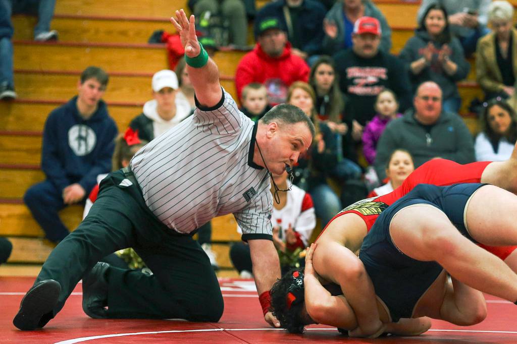 Al Rivers counts as Marysvilles Ikaika Nawelhi tops Arlingtons Connor Stackman at Marysville Pilchuck High School on Jan. 25. (Kevin Clark / The Herald)