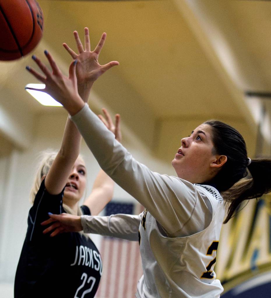Mariners Hannah Hezekiah (left) attempts a shot past Jacksons Lauren Schillberg at Mariner High School in Everett on Jan. 31. (Kevin Clark / The Herald)