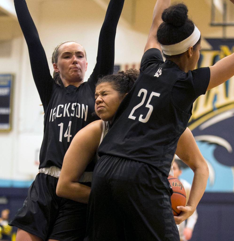 Mariners Nia Hawkins attempts a drive with Jacksons Alexa Martin (left) and Sydney Carter defending at Mariner High School in Everett on Jan. 31. (Kevin Clark / The Herald)
