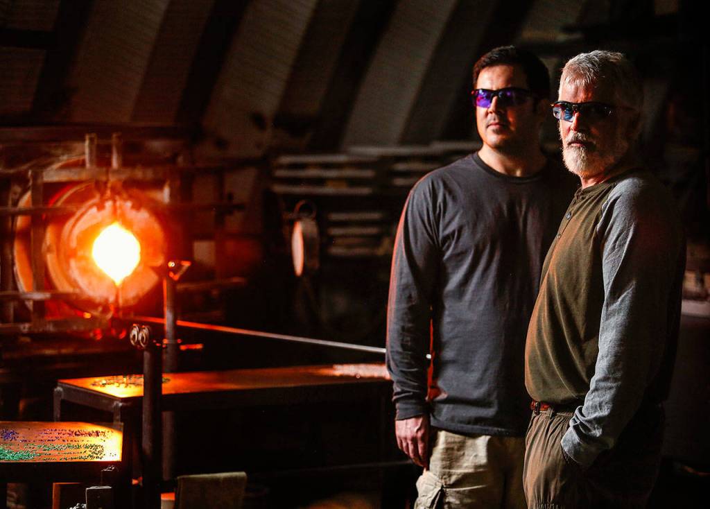 Mark Ellinger and his son, Marcus have been busy making the glass floats for the Great Northwest Glass Quest, which runs through Feb. 25. (Dan Bates / The Herald)