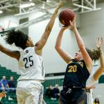 Mariners Taliyah Clark (20) takes a shot as Jacksons Sydney Carter (25) defends during a playoff game on Feb. 8, 2018, at Jackson High School in Mill Creek. (Ian Terry / The Herald)