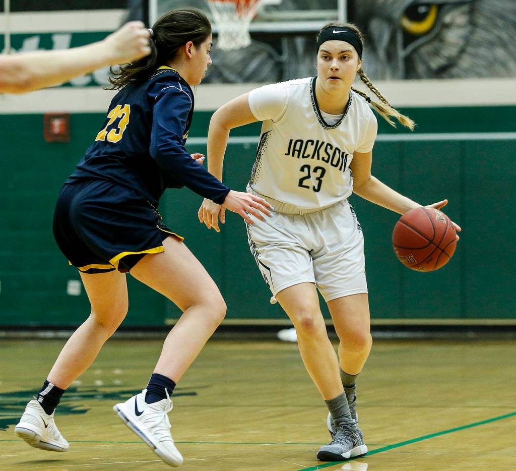 Jacksons Olivia Skibiel (right) dribbles past Mariners Hannah Hezekiah during a playoff game on Feb. 8, 2018, at Jackson High School in Mill Creek. (Ian Terry / The Herald)