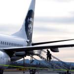 As a private plane passes by, passengers board to the rear of jet at Bellingham International Airport in Bellingham. Bellinghams airport director expects that a new terminal in Everett will draw less than 5 percent of air passengers away from Bellingham. (Andy Bronson / The Herald)
