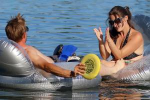 Jonathan Townsend paddles to the shore towing Kimberly Kaminski Wednesday afternoon at Silver Lake in Everett on July 12, 2017. (Kevin Clark / Herald file)