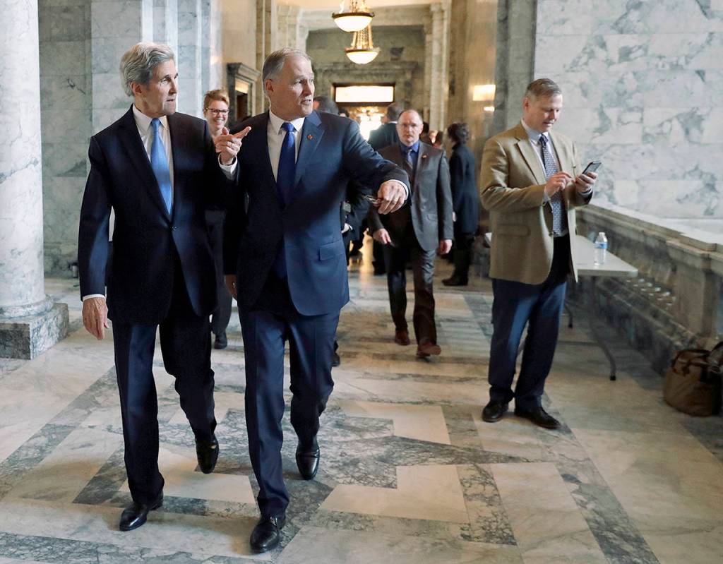 John Kerry and Jay Inslee walk at the state Capitol in Olympia. (Ted S. Warren / Associated Press)
