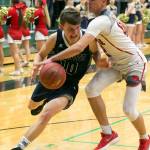 Marysville Pilchucks Josiah Gould reaches across and fouls Arlingtons Anthony Whitis during a district playoff game on Feb. 14, 2018, at Jackson High School in Mill Creek. (Kevin Clark / The Herald)