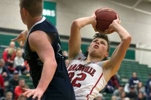 Marysville-Pilchucks Aaron Kalab attempts a shot past Arlingtons Caden Smith during the 3A semifinals Thursday night at Henry M. Jackson High School in Everett on February 14, 2018. (Kevin Clark / The Daily Herald)